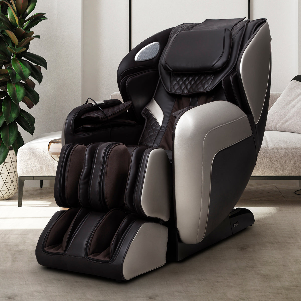 Brown OS-Atai massage chair in a room with a plant and sofa