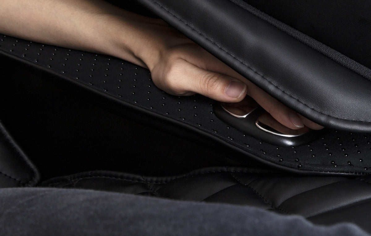 A person's index finger rests on the Osaki OS-4000XT Massage Chair tension sensor
