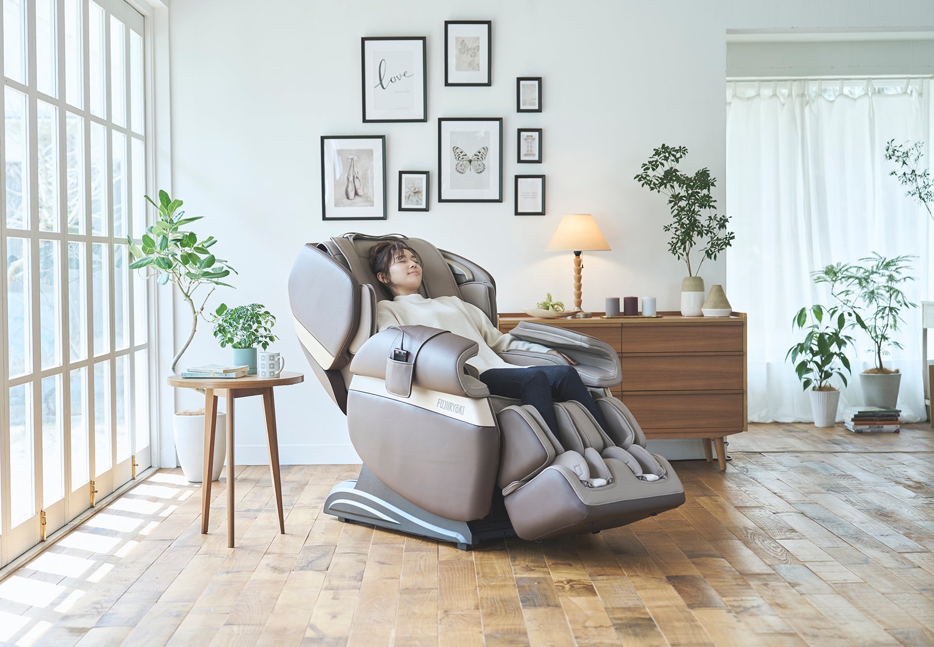 Woman relaxing in a Fujiiryoki Calm Plus Massage Chair in a home setting