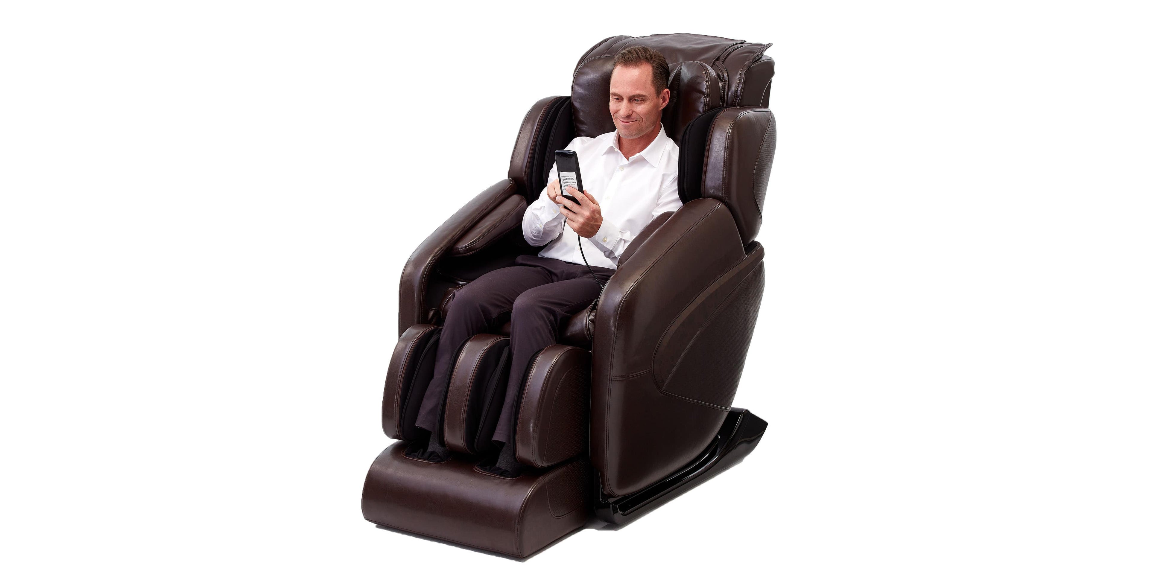 Man using the remote controller and sitting in an Espresso Inner Balance Jin Zero Gravity Massage Chair on a white background